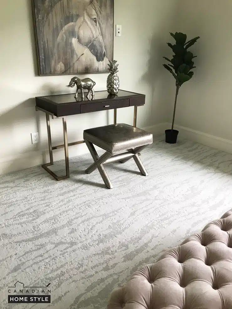 A room with a desk and a painting on the wall featuring carpet in Vancouver.