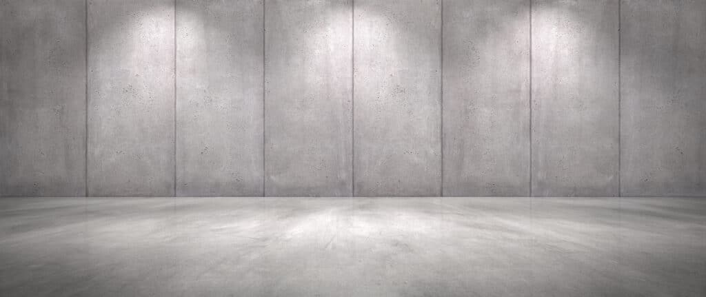 An empty room with a concrete wall and flooring.