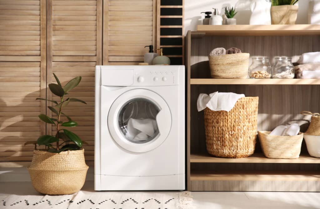A laundry room with a washing machine and plumbing.