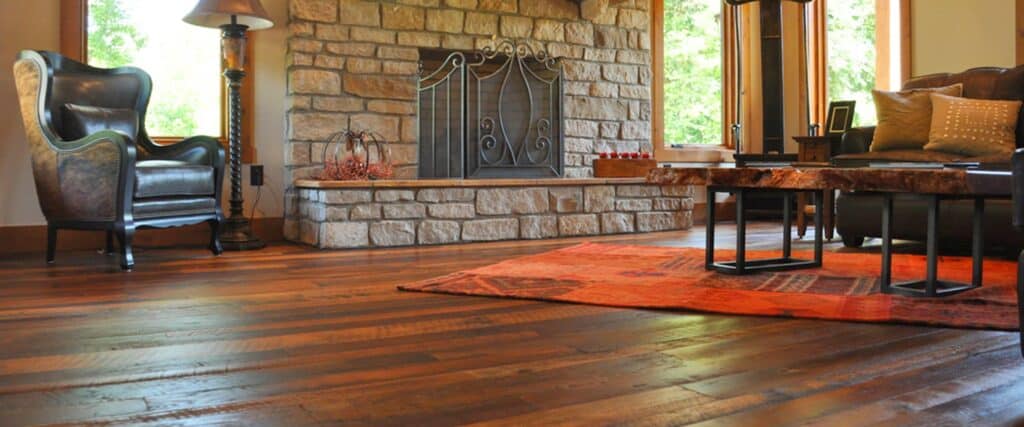 A living room with wood floors and a fireplace.