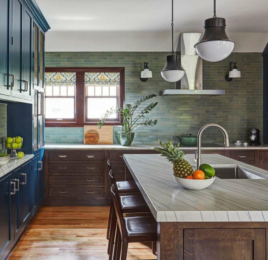 A kitchen with blue cabinets and hardwood floors.