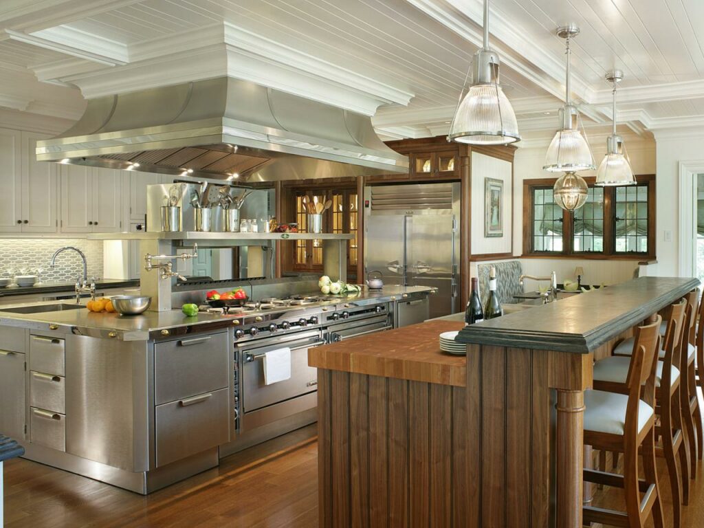 A kitchen with a large island and stainless steel appliances.