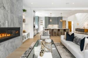 A modern living room with an open concept kitchen and a fireplace.