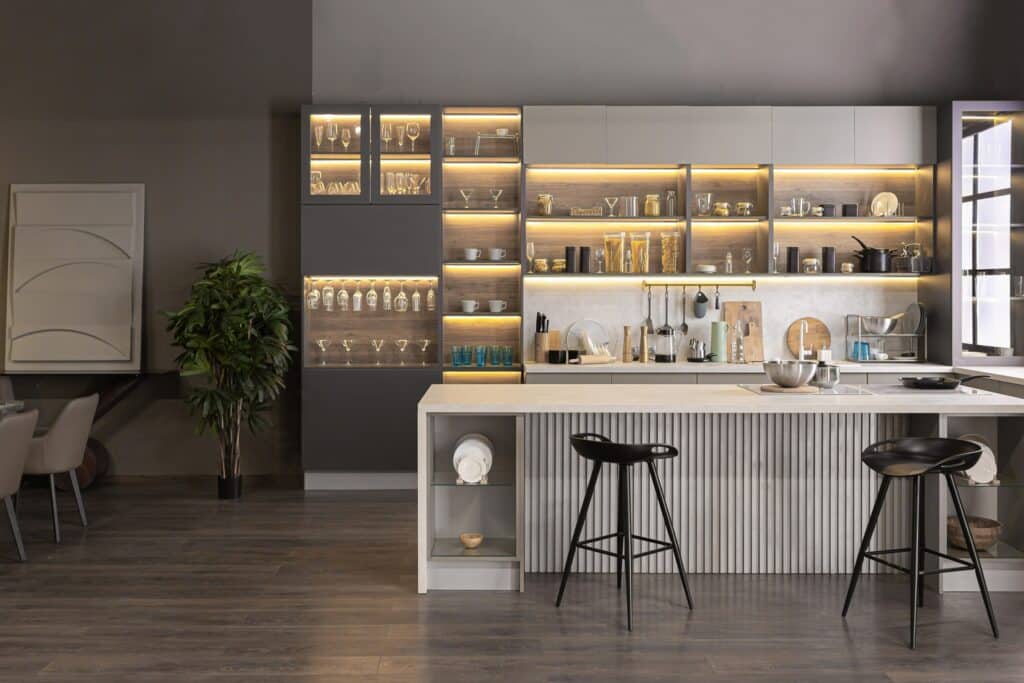 A kitchen with a bar and stools featuring the best kitchen cabinets in Vancouver.