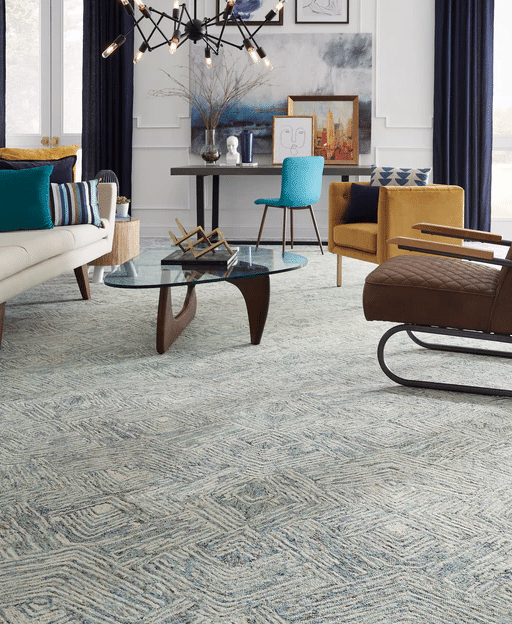 Factors to Consider Before Choosing Wall to Wall Carpeting in a Living Room with Blue Rug and Furniture.