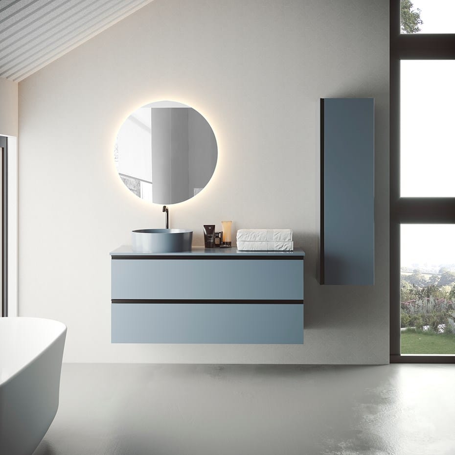 A bathroom with a round mirror and a tub.