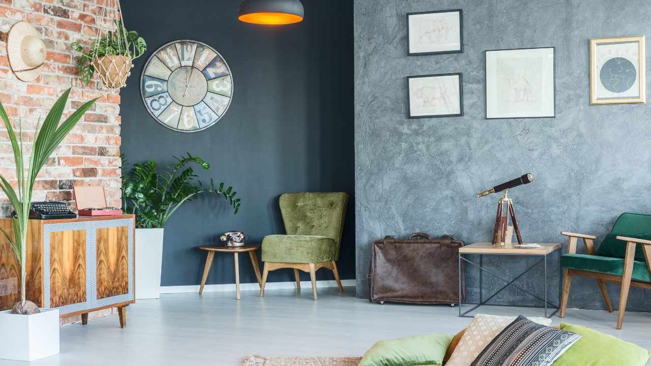 A living room with a brick wall and green furniture.