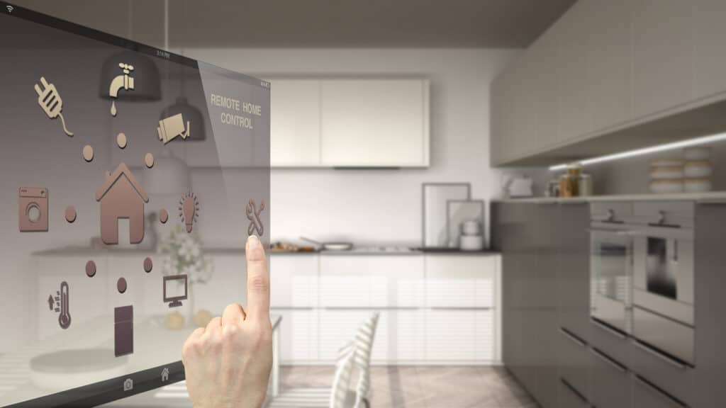 A person is pointing at a digital screen in a smart kitchen.