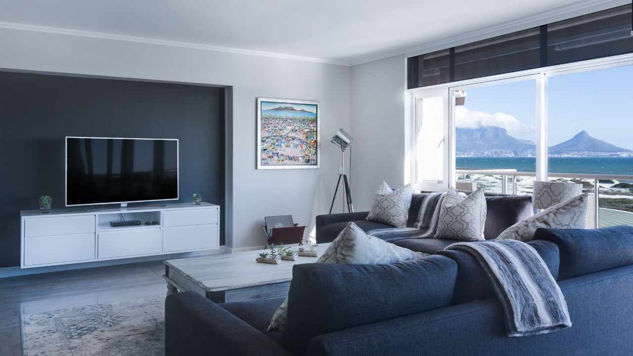A living room with a view of the ocean and table mountain.