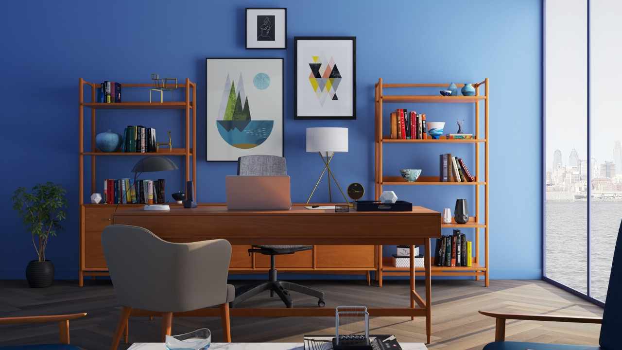 A home office with blue walls and a desk.