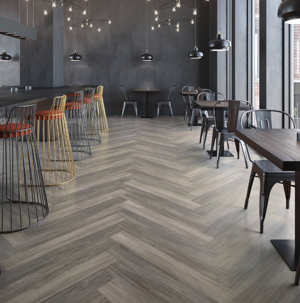 A restaurant featuring a Mannington Flooring with wooden floor and chairs.