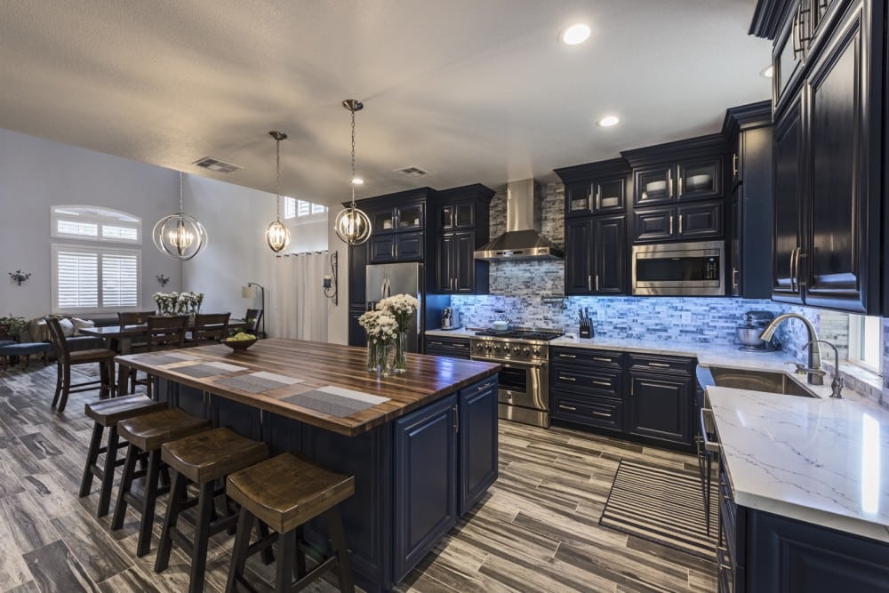 An ideal kitchen design with blue cabinets and a center island.