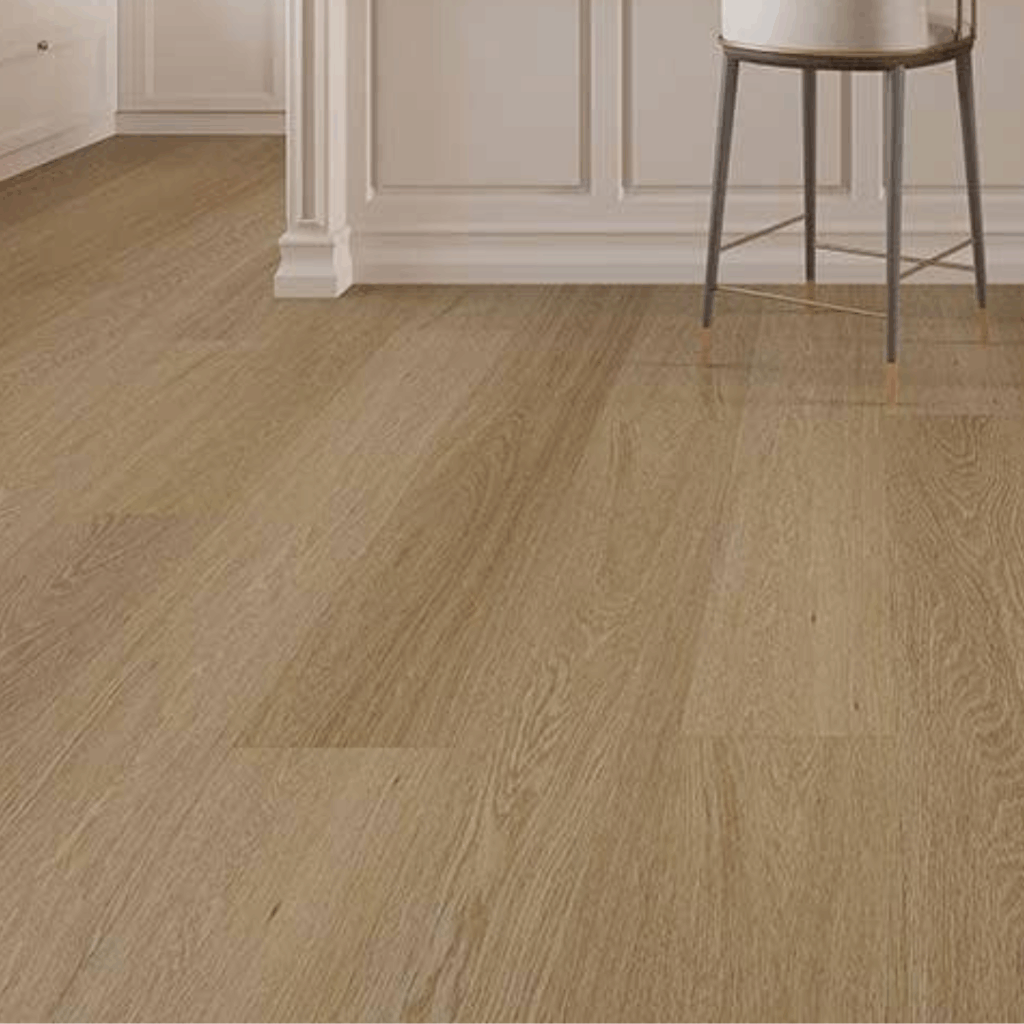 Light wood flooring in a room with white paneled walls and a round metal stool with a cushion.