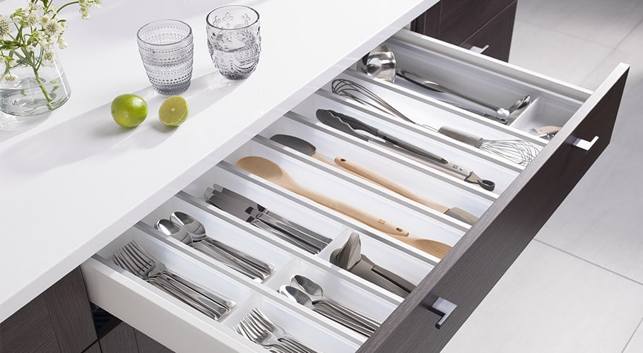 A kitchen with a drawer full of utensils and utensils.