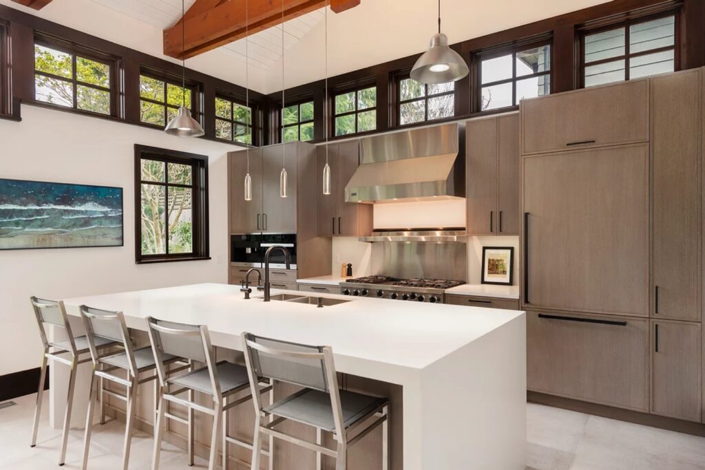 A modern Canadian Home style kitchen with a center island and bar stools.