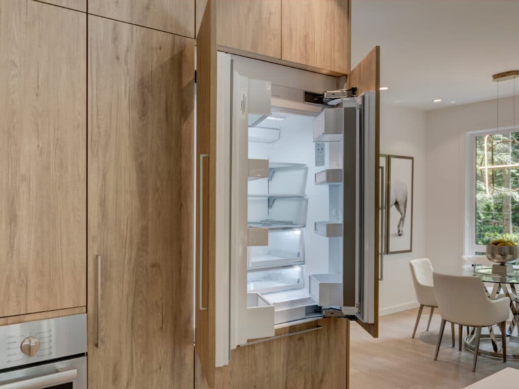 A Vancouver kitchen renovation with a refrigerator and a dining table.