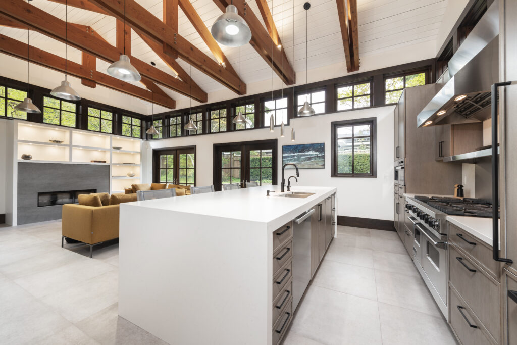 A modern Canadian Home style kitchen with wood beams and a large island.