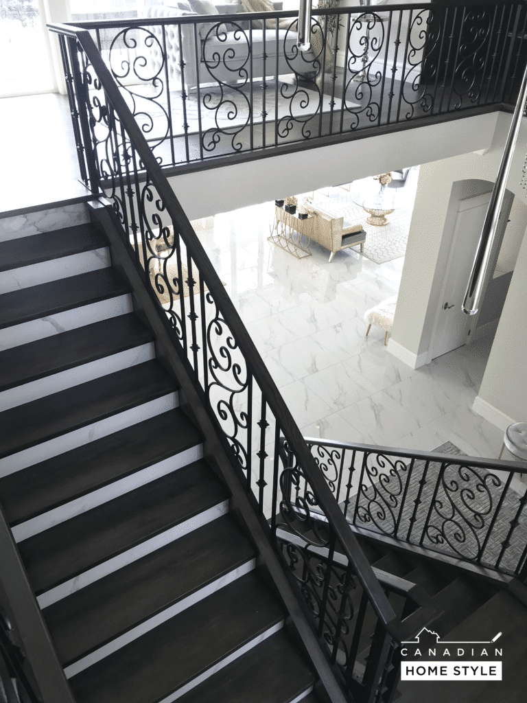 Black wrought iron stair railings enhance the elegance and sophistication of a home's interior, providing a stylish and secure feature.