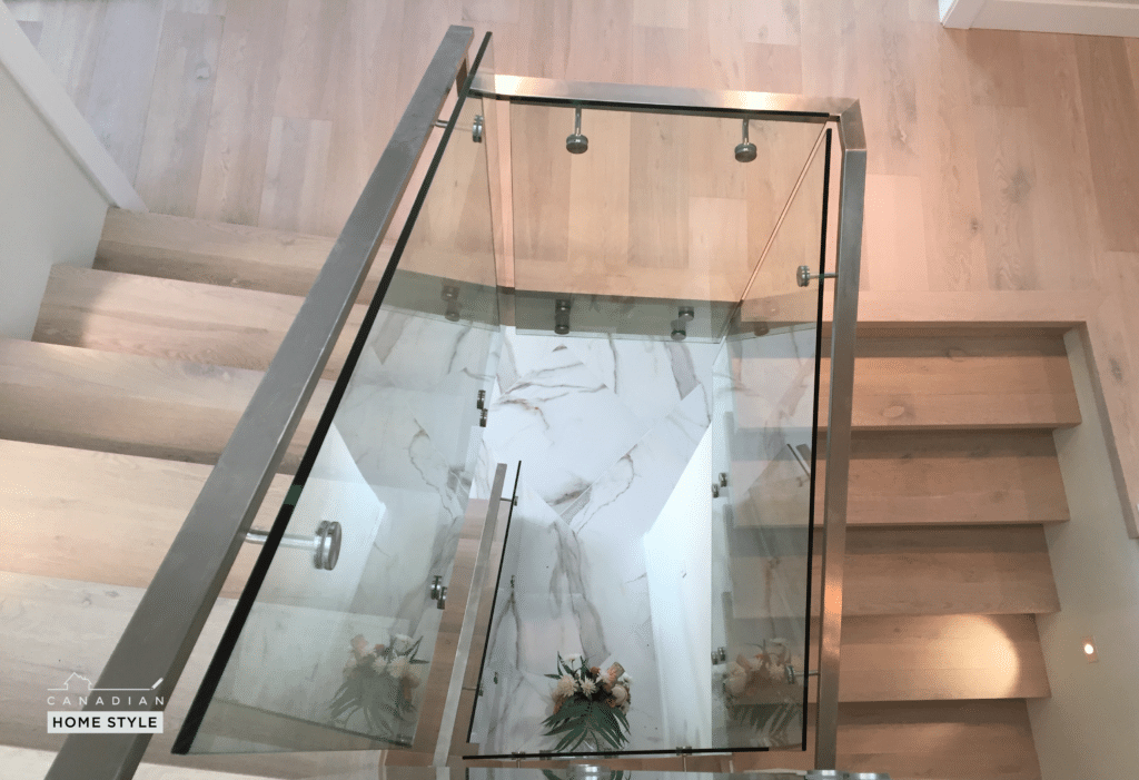 Vancouver Renovation Photos - A modern glass stair railing enhances the aesthetic appeal of a home.