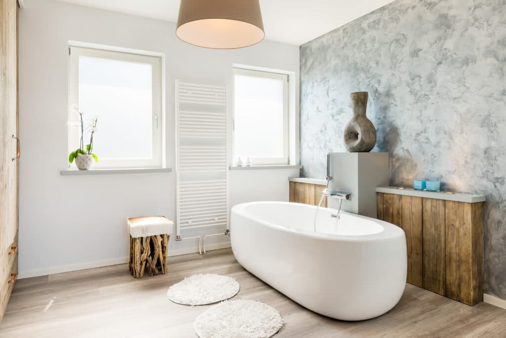 A Canadian Home style bathroom with a wooden floor and a white tub.