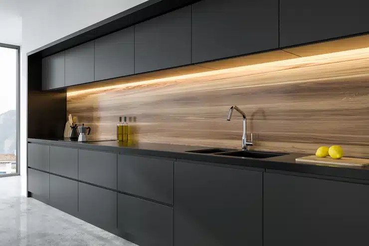 A modern kitchen with sleek black cabinets and elegant wood accents, featuring a stunning kitchen cabinet design.