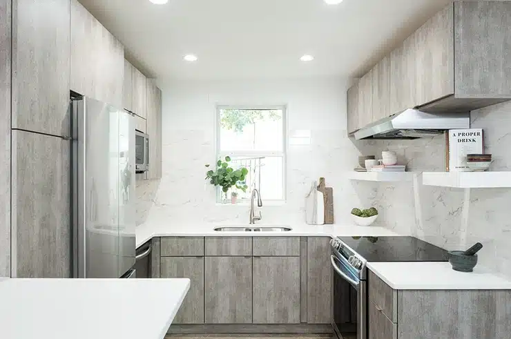 A kitchen with white cabinets and stainless steel appliances.