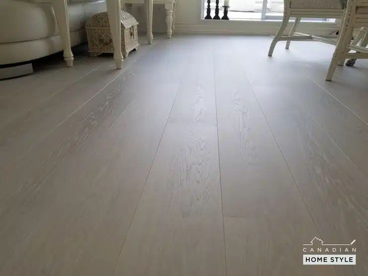 A white wooden floor in a living room, made of hardwood.