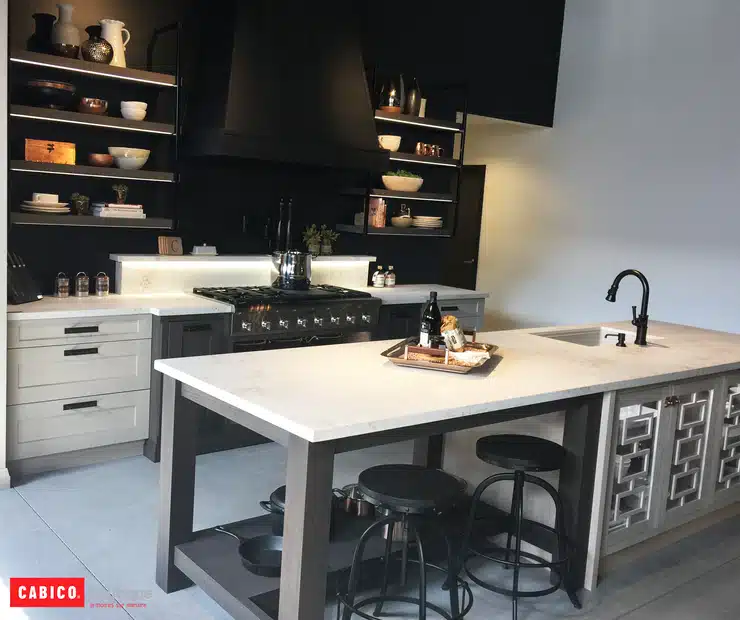 A white kitchen featuring Vancouver custom cabinetry, with black counter tops and stools.