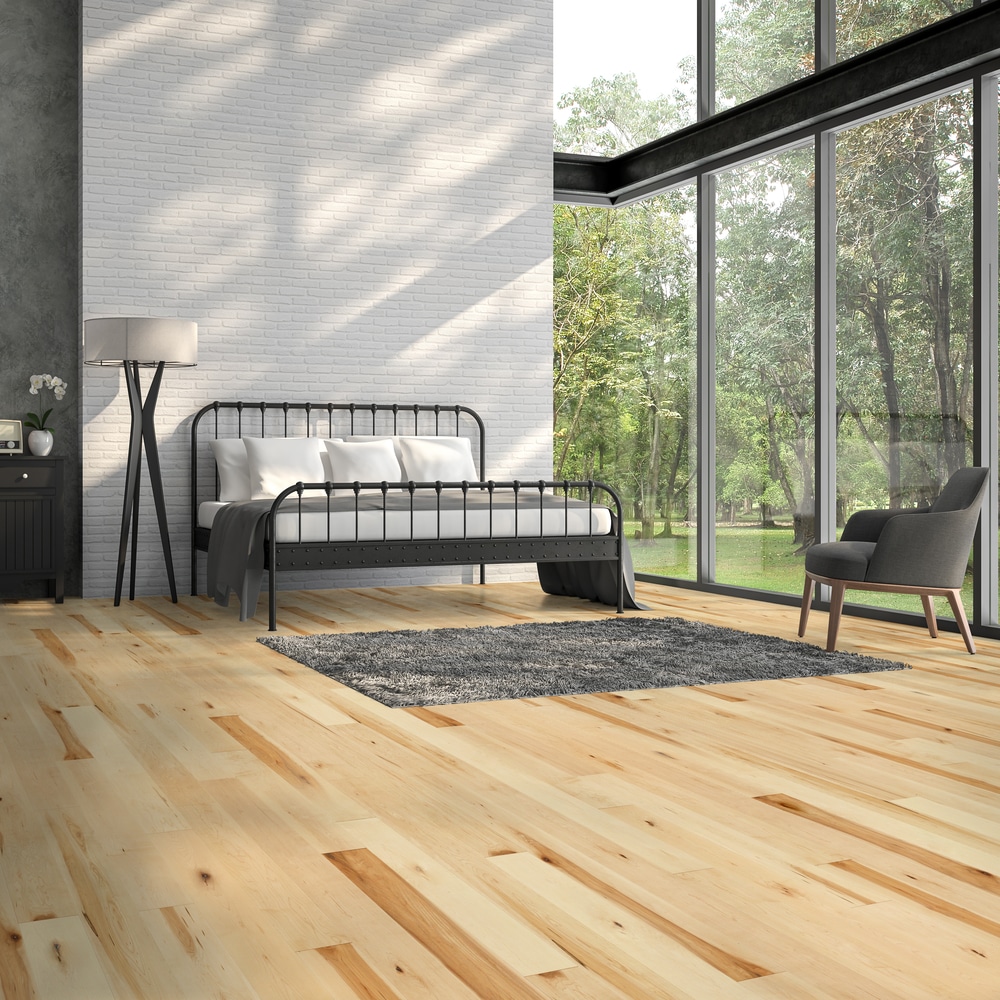 A bedroom with Mercier hardwood floors and a bed.