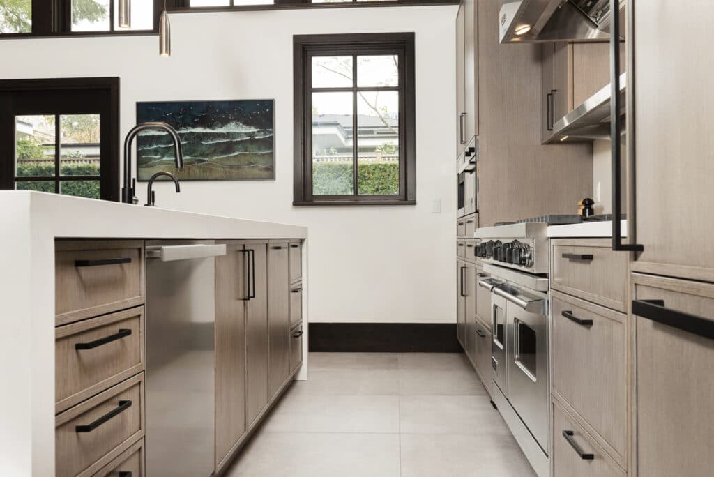 A kitchen with stainless steel appliances and wooden cabinets, showcasing a sleek and modern design.