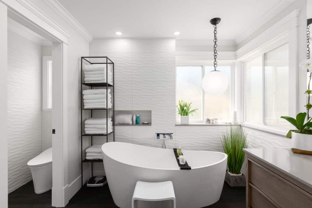 A white bathroom with a bathtub and a sink, designed with a focus on bath design.
