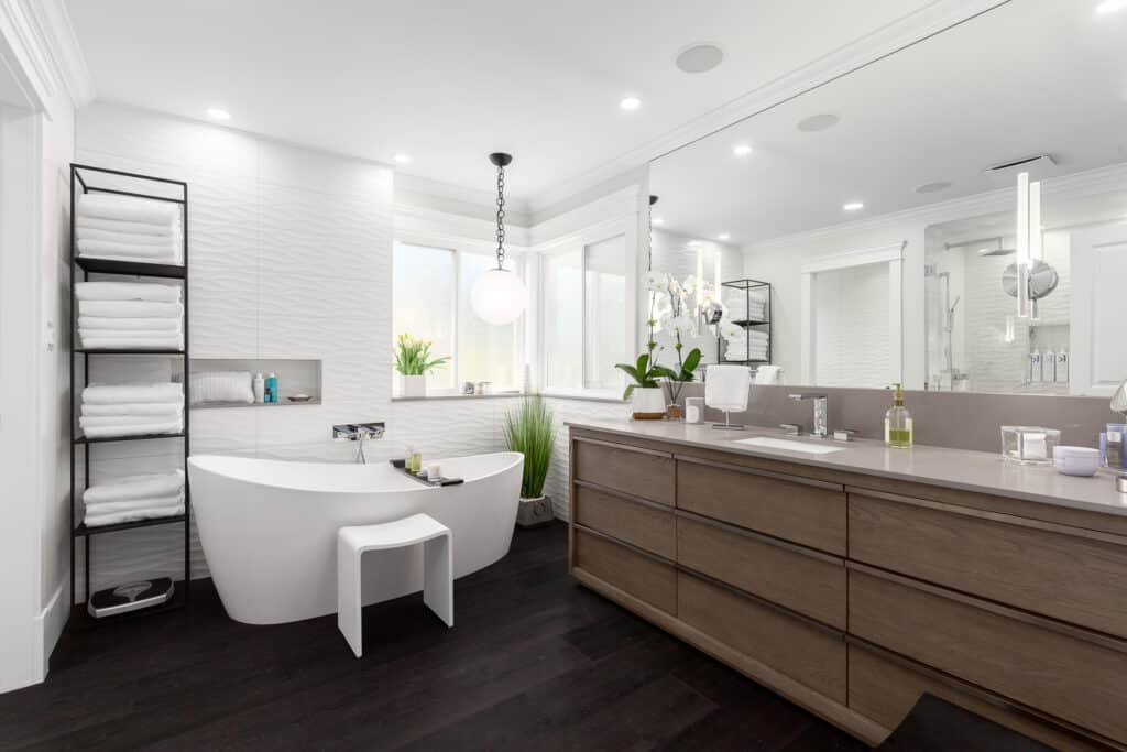 A modern bathroom with a sleek bathtub and stylish sink, designed with expertise in kitchen and bath design.