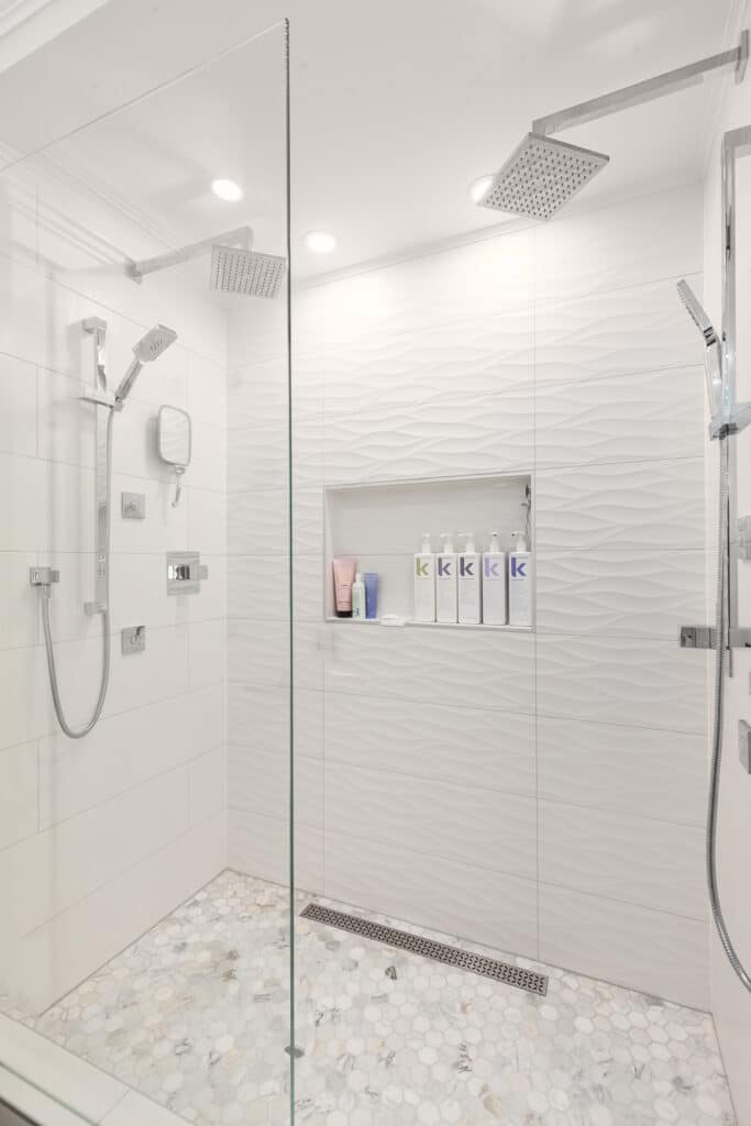 Bathroom Gallery: This modern bathroom showcases an elegant white color scheme and features a stunning glass shower stall.