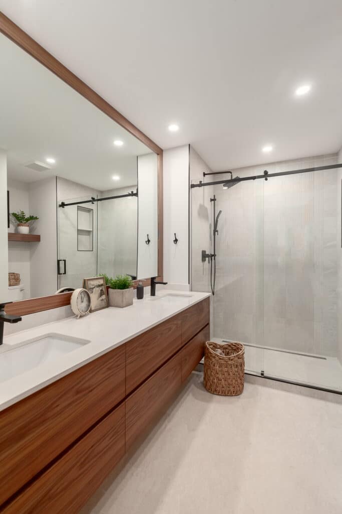 Bathroom Gallery: A modern bathroom featuring wooden cabinets and a glass shower.