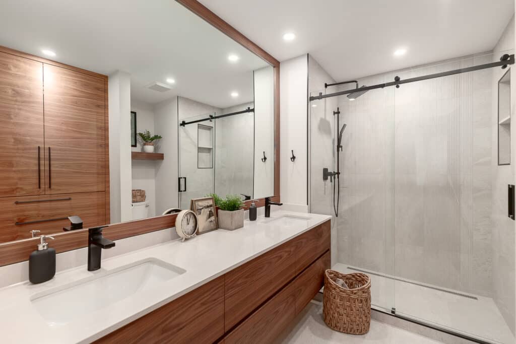 Bathroom Gallery featuring a modern bathroom with wood cabinets and a glass shower.