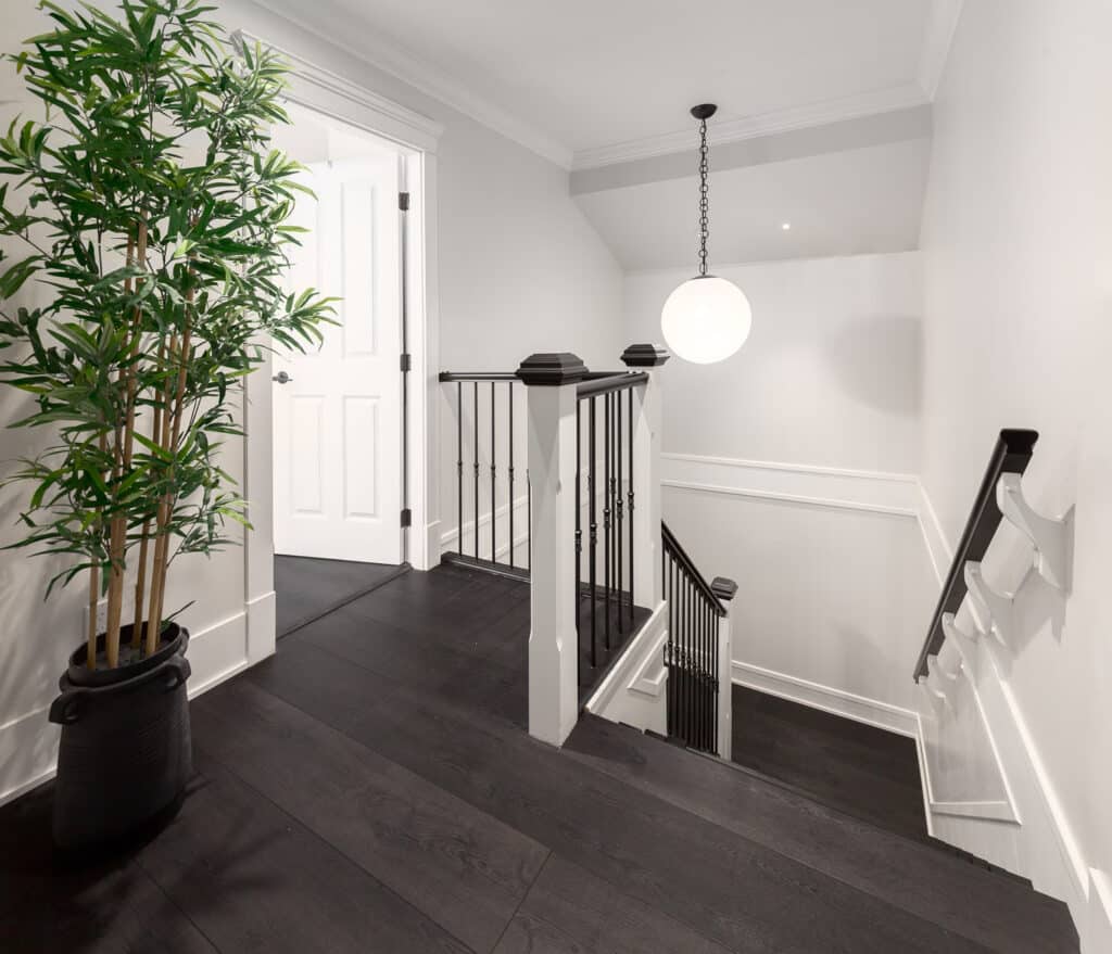 A black and white stairway with a potted plant in the Bathroom Gallery.