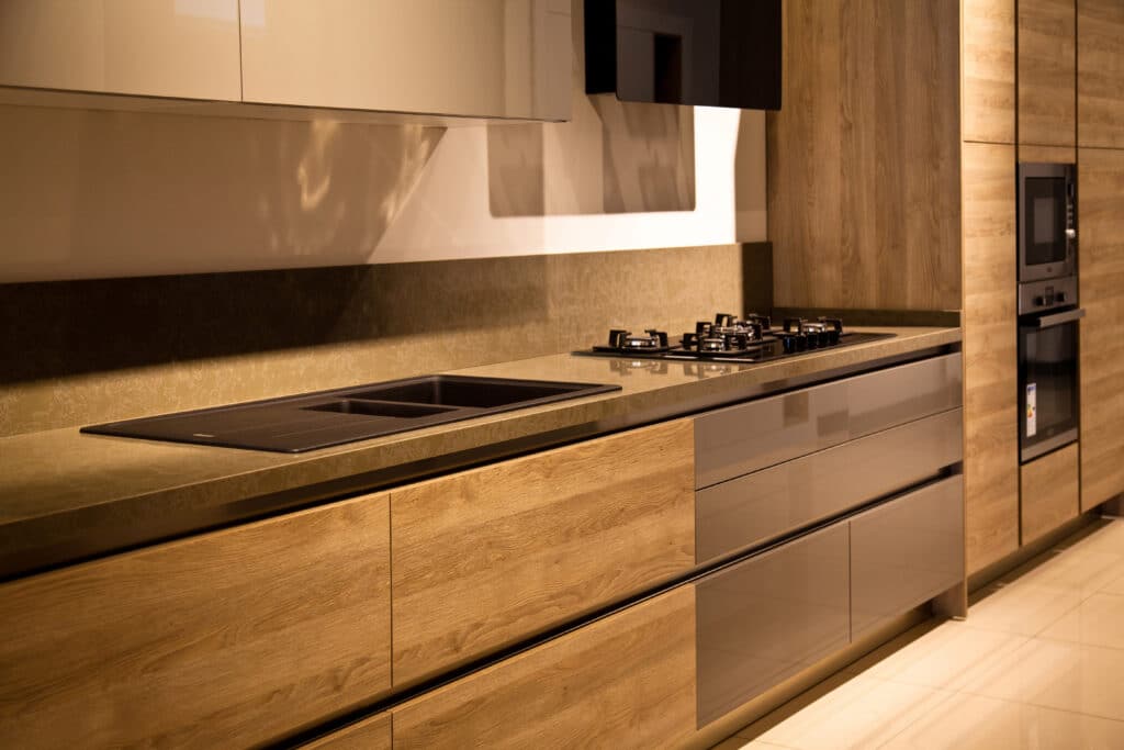 A modern kitchen with oak cabinets and stainless steel appliances.