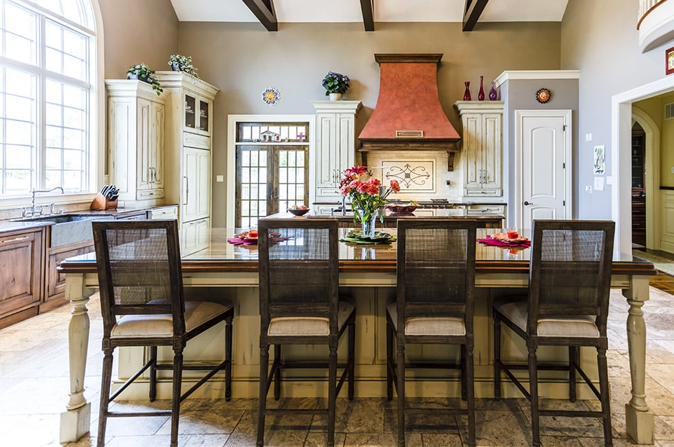 A family kitchen designed with a center island and bar stools.