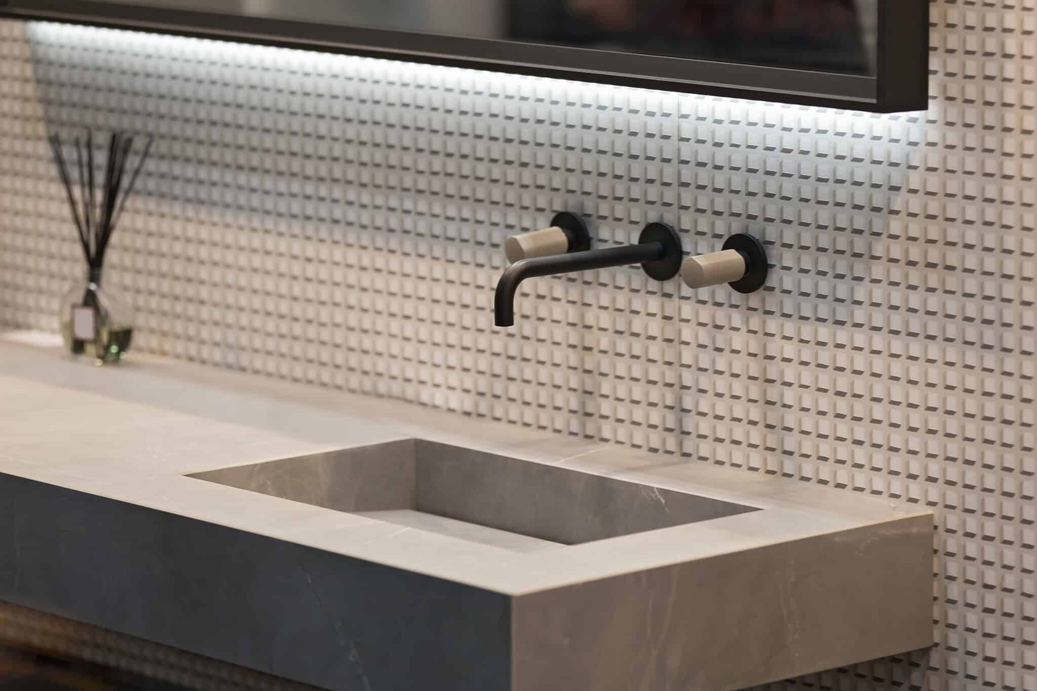 A modern bathroom with a sink and mirror featuring a vanity.