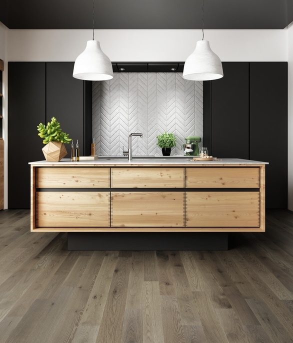 A modern kitchen with wood floor finishes and black walls.