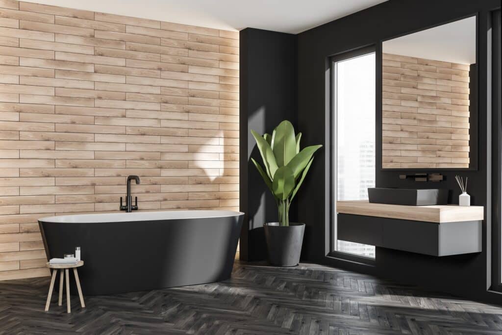A black and white bathroom with a wood look porcelain tiles floor.