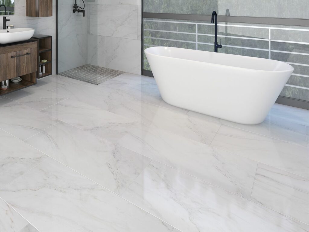 A bathroom with white marble floors and a tub.