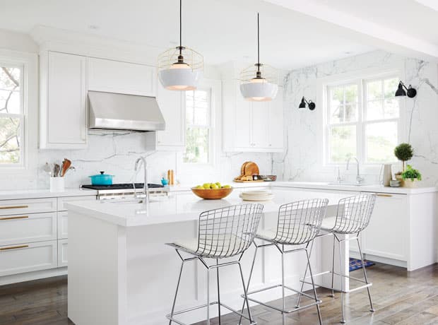 A white kitchen with white cabinets and white countertops.