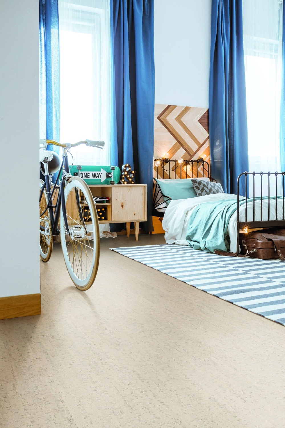 A bedroom featuring the benefits of cork flooring with a bicycle in the middle of the room.