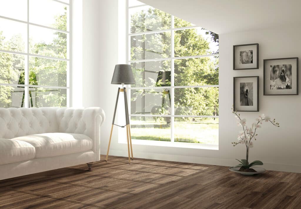 A living room with wooden floors and a white couch.