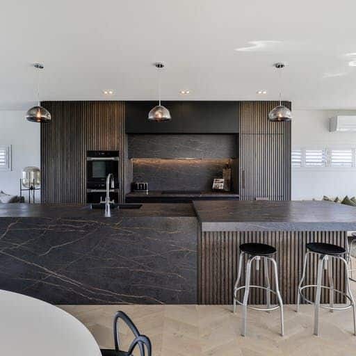 A modern kitchen with Dekton black marble counter tops.