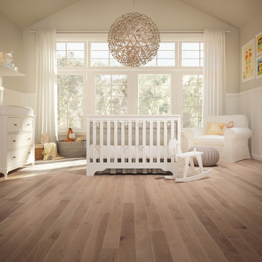 A baby's room in Vancouver with hardwood floors and a white crib.