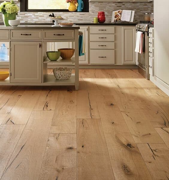 Vancouver laminate flooring: A kitchen with Vancouver laminate flooring and white cabinets.