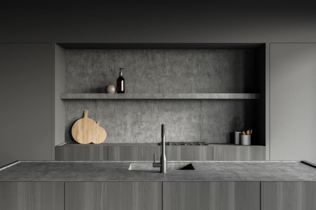 A grey kitchen with a wooden counter top, showcasing the latest 2023 kitchen design trends.