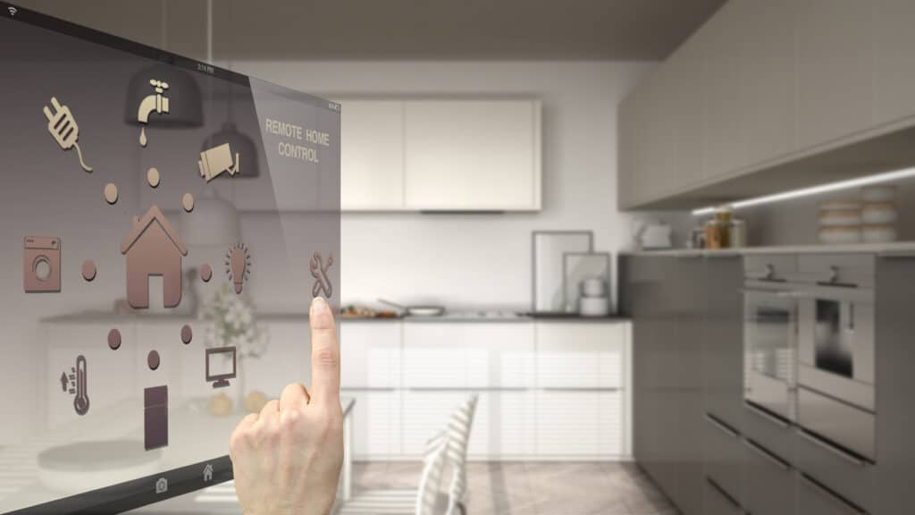 A person is pointing at a digital screen in a smart kitchen.